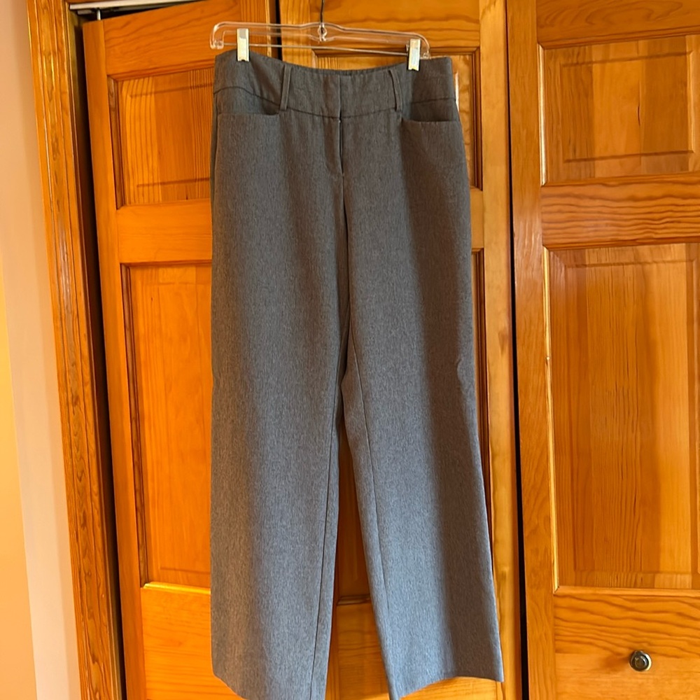 Gray dress pants pockets in front and back , belt loops, zipper front.
